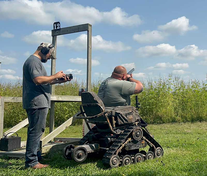 veteran participating in chair shooting clay discs
